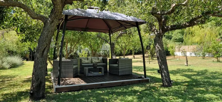 The garden gazebo with outdoor sofas under the olive trees