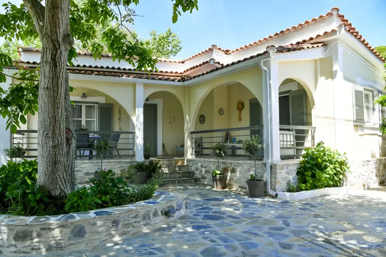 The arched veranda and the stone-paved yard