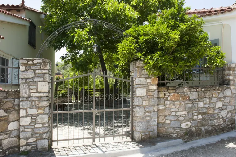 The iron gate in the old stone wall