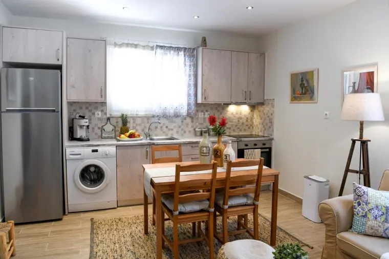 The kitchen, with fridge-freezer, washing machine and dining table