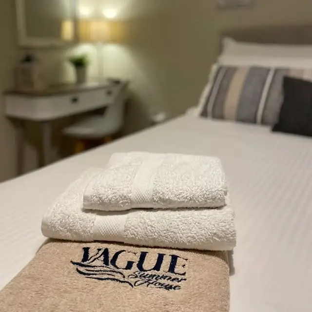 Towels embroidered with the Vague Summer House logo