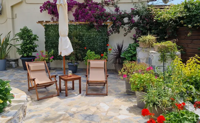 Deckchairs on the flowered stone patio