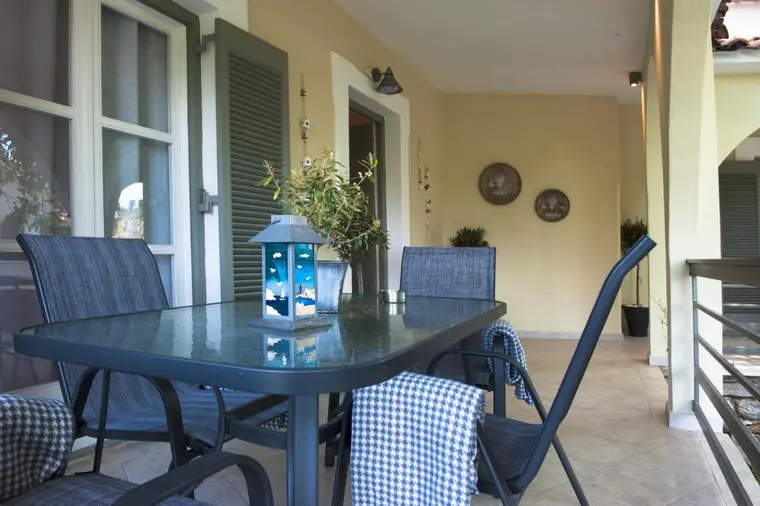 The glass dining table on the veranda